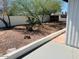 Desert landscaped backyard, with rock and mature vegetation at 2103 W Missouri Ave, Phoenix, AZ 85015