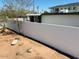 View of backyard with large wall featuring minimal landscaping and rock features at 2103 W Missouri Ave, Phoenix, AZ 85015