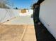 Spacious backyard featuring a concrete patio, dirt area, and brick wall at 2103 W Missouri Ave, Phoenix, AZ 85015