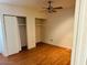Bedroom with hardwood floor, closet, and basic ceiling fan at 2103 W Missouri Ave, Phoenix, AZ 85015
