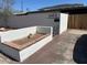 The exterior of the apartment features white stucco and a small planter at 2103 W Missouri Ave, Phoenix, AZ 85015