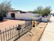 Exterior view of the front yard featuring a black iron fence and low maintenance yard at 2103 W Missouri Ave, Phoenix, AZ 85015