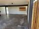 View of an empty attached garage featuring some cabinet storage on the back wall at 2103 W Missouri Ave, Phoenix, AZ 85015