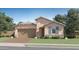 Charming single-Gathering home with a two-car garage, stone accents, and a well-manicured lawn at 23073 E Saddle Way, Queen Creek, AZ 85142