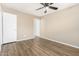 Neutral bedroom with wood-look floors, closet, and door at 2645 W Elm St, Phoenix, AZ 85017