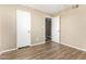 Neutral bedroom features wood-look floors, a closet, and a connecting door at 2645 W Elm St, Phoenix, AZ 85017