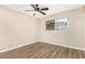 Neutral bedroom featuring wood-look floors, a ceiling fan, and window at 2645 W Elm St, Phoenix, AZ 85017