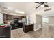 Kitchen with stainless steel appliances, dark cabinets, breakfast bar, and adjacent laundry room at 2645 W Elm St, Phoenix, AZ 85017