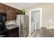 The kitchen features stainless steel appliances, dark cabinets, and an adjacent laundry room at 2645 W Elm St, Phoenix, AZ 85017
