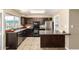 Cozy kitchen features dark cabinetry, modern appliances, and a breakfast bar for casual dining at 2645 W Elm St, Phoenix, AZ 85017
