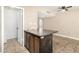 Open living room featuring a ceiling fan and tile floors and adjacent to kitchen at 2645 W Elm St, Phoenix, AZ 85017