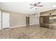 Spacious living room with neutral tones, tile flooring, a ceiling fan and a mirrored wall at 2645 W Elm St, Phoenix, AZ 85017