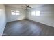 Bedroom with neutral paint, new gray wood-look floors, and good natural light at 2724 W Highland Ave, Phoenix, AZ 85017