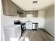Modern kitchen featuring stainless steel appliances, gray cabinets, new countertops, and gray wood-look floors at 2724 W Highland Ave, Phoenix, AZ 85017