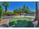 Spacious backyard with putting green, trampoline, mature trees, and a luxurious pool with waterfall feature at 3114 E Capricorn Way, Chandler, AZ 85249