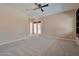 Spacious bedroom featuring neutral carpet, and access to the backyard through glass patio doors at 3114 E Capricorn Way, Chandler, AZ 85249