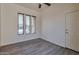 Clean, bright bedroom with hardwood floors, three windows and a door to the hallway at 3114 E Capricorn Way, Chandler, AZ 85249