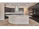 Modern kitchen featuring a large island, granite countertops, stainless steel appliances, and dark cabinets at 3114 E Capricorn Way, Chandler, AZ 85249