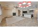Open concept living area featuring tile floors, fireplace, kitchen island, and modern lighting at 3114 E Capricorn Way, Chandler, AZ 85249