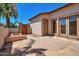 Private outdoor patio featuring stone pavers, a built-in fire pit, and doors leading into the home at 3114 E Capricorn Way, Chandler, AZ 85249
