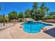 Beautiful pool featuring a rock waterfall design, surrounded by lush landscaping and a spacious patio area at 3114 E Capricorn Way, Chandler, AZ 85249