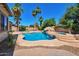 Backyard pool and hot tub with rock waterfall feature, lush landscaping, and a concrete patio at 3114 E Capricorn Way, Chandler, AZ 85249