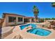 An inviting pool and spa with rock accents sits next to the home, all surrounded by a concrete patio at 3114 E Capricorn Way, Chandler, AZ 85249