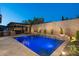 Inviting backyard with pool, waterfall feature, pergola with lighting and travertine pavers at 31311 N 138Th Ave, Peoria, AZ 85383