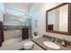 Bathroom featuring a shower and tub, decorative mirror, and granite countertops at 31311 N 138Th Ave, Peoria, AZ 85383