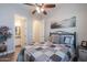 Bright bedroom with ceiling fan, ensuite bathroom, and views into adjoining rooms at 31311 N 138Th Ave, Peoria, AZ 85383