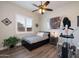 Bright bedroom with wood floors, a ceiling fan, and modern art at 31311 N 138Th Ave, Peoria, AZ 85383