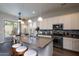 Bright kitchen features granite counters, stainless appliances, and an island with bar seating at 31311 N 138Th Ave, Peoria, AZ 85383
