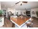 Open-concept floor plan with dining area, kitchen, and living room with fireplace at 31311 N 138Th Ave, Peoria, AZ 85383