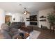 Relaxing living room featuring fireplace, large TV, and cozy furnishings at 31311 N 138Th Ave, Peoria, AZ 85383