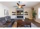 Cozy living room featuring a fireplace, large TV, and comfortable seating at 31311 N 138Th Ave, Peoria, AZ 85383