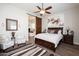 Bedroom with a decorative ceiling fan, ensuite bath, and artwork above the bed at 31311 N 138Th Ave, Peoria, AZ 85383