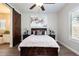 Bedroom with a decorative painting, hardwood floors, and an ensuite bath at 31311 N 138Th Ave, Peoria, AZ 85383