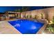 Backyard pool area with waterfall feature, barbecue, spa, and outdoor lighting for relaxing evenings at 31311 N 138Th Ave, Peoria, AZ 85383