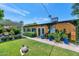 Charming backyard with lush green lawn, brick pathway, colorful plants, and turtle statue at 3351 N 6Th Ave, Phoenix, AZ 85013