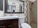Well-lit bathroom featuring a modern vanity, patterned shower curtain, and tiled walk-in shower at 3351 N 6Th Ave, Phoenix, AZ 85013