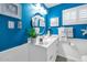 Stylish bathroom with bright blue walls, modern fixtures, and a decorative plant at 3351 N 6Th Ave, Phoenix, AZ 85013