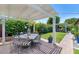 Backyard oasis featuring an outdoor dining area with a pergola and lush landscaping at 3351 N 6Th Ave, Phoenix, AZ 85013