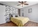A bedroom with a ceiling fan, wood-look floors, wallpaper and ample natural light at 3500 N Hayden Rd # 801, Scottsdale, AZ 85251
