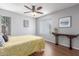 Bright bedroom features wood-look floors, a ceiling fan, and neutral paint at 3500 N Hayden Rd # 801, Scottsdale, AZ 85251
