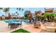 Relaxing community pool with lounge chairs, tables, and tropical landscaping creates a resort-style atmosphere at 3500 N Hayden Rd # 801, Scottsdale, AZ 85251