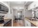This kitchen offers a dining area with elegant chandelier lighting and stainless steel appliances at 3500 N Hayden Rd # 801, Scottsdale, AZ 85251