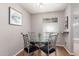 Dining area with a glass table, stylish chairs, and a window with natural light at 3500 N Hayden Rd # 801, Scottsdale, AZ 85251