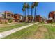 View of the community showcasing manicured lawns, mature palm trees, and well-maintained building exteriors on a sunny day at 3500 N Hayden Rd # 801, Scottsdale, AZ 85251