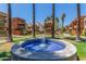 Community featuring lush landscaping, mature palms, and a central water fountain that enhances the property's appeal at 3500 N Hayden Rd # 801, Scottsdale, AZ 85251