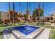 View of a refreshing water fountain amidst well-maintained greenery, palm trees, and the exteriors of community buildings at 3500 N Hayden Rd # 801, Scottsdale, AZ 85251
